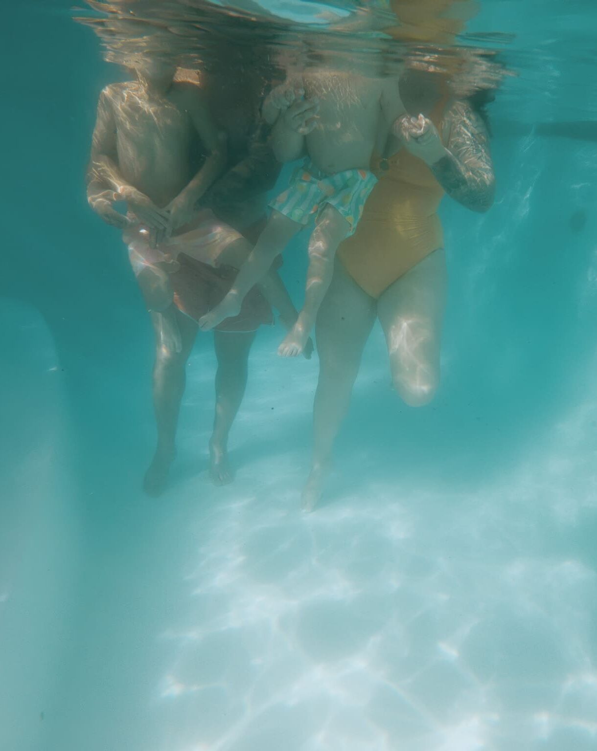 Family underwater portrait in their pool